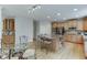 An open kitchen showcases granite counters, stainless steel appliances, and a central island with bar stool seating at 1718 Autumn Sage Dr, Dacula, GA 30019
