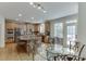 Bright eat-in kitchen with granite counters, stainless appliances, and breakfast bar seating at the island at 1718 Autumn Sage Dr, Dacula, GA 30019