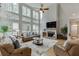Inviting living room with a fireplace, high ceilings, large windows, and a comfortable seating area at 1718 Autumn Sage Dr, Dacula, GA 30019