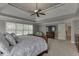 This main bedroom features a king size bed, tv and carpeted flooring at 1718 Autumn Sage Dr, Dacula, GA 30019