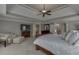 This main bedroom features a king size bed, tv and carpeted flooring at 1718 Autumn Sage Dr, Dacula, GA 30019