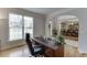 This office features a wooden desk with natural light streaming in at 1718 Autumn Sage Dr, Dacula, GA 30019