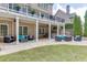 Outdoor patio area with comfortable seating, a fire pit, and access to the green backyard at 1718 Autumn Sage Dr, Dacula, GA 30019