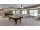 Spacious recreation room featuring a pool table, large seating area, and bar, perfect for entertaining at 1718 Autumn Sage Dr, Dacula, GA 30019