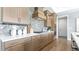 Stylish kitchen featuring custom cabinetry, a herringbone tile backsplash, stainless steel appliances, and a gas cooktop at 4210 Provenance Trl, Cumming, GA 30028