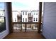 Balcony view of the home's exterior featuring white siding and a wood balcony with railing at 502 Clover Ln, Alpharetta, GA 30009