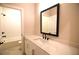 Bathroom with a white vanity, a black framed mirror, and a tub shower combo at 502 Clover Ln, Alpharetta, GA 30009