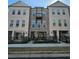 Attractive townhome showcases brick facade, balcony, and fenced courtyard at 502 Clover Ln, Alpharetta, GA 30009