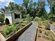 Landscaped garden featuring a shed and raised garden beds with gravel pathways at 502 Clover Ln, Alpharetta, GA 30009