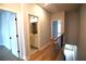 Hallway with hardwood floors leading to a bathroom and a bedroom at 502 Clover Ln, Alpharetta, GA 30009