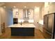 Modern kitchen features white cabinets, stainless steel appliances, and an island at 502 Clover Ln, Alpharetta, GA 30009