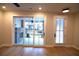 Spacious living room boasts hardwood floors and sliding glass doors to the patio at 502 Clover Ln, Alpharetta, GA 30009
