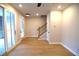 Open-concept living room features hardwood floors, a staircase, and sliding glass doors at 502 Clover Ln, Alpharetta, GA 30009