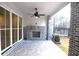 Relaxing covered patio features a ceiling fan and an outdoor fireplace at 502 Clover Ln, Alpharetta, GA 30009