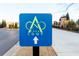 Community street sign in a residential area. Landscaped entrance to the Alpha Loop at 502 Clover Ln, Alpharetta, GA 30009