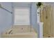 Bright bathroom featuring a soaking tub with jets and a separate shower stall at 524 Lambeth Dr, Hiram, GA 30141