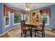 Charming dining area with large windows and a decorative china cabinet at 524 Lambeth Dr, Hiram, GA 30141