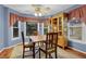 Inviting dining area with beautiful windows, wood table and adjacent china cabinet at 524 Lambeth Dr, Hiram, GA 30141