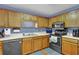 Efficient kitchen equipped with wooden cabinets and stainless steel appliances for modern living at 524 Lambeth Dr, Hiram, GA 30141