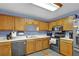 Cozy kitchen features light wood cabinets and a full suite of modern appliances at 524 Lambeth Dr, Hiram, GA 30141