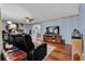 Open living room with hardwood floors, large screen TV, and a ceiling fan at 524 Lambeth Dr, Hiram, GA 30141