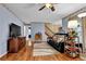 Cozy living room featuring wood floors, a ceiling fan, and comfortable black couch at 524 Lambeth Dr, Hiram, GA 30141
