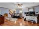 Living room featuring hardwood floors, stairs and a large ceiling fan at 524 Lambeth Dr, Hiram, GA 30141