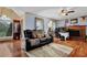Open living room featuring hardwood floors, a fireplace, and ceiling fan at 524 Lambeth Dr, Hiram, GA 30141
