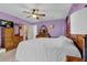 Bedroom with light purple walls, a ceiling fan and carpeted floors at 524 Lambeth Dr, Hiram, GA 30141