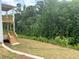 Spacious backyard with a walkout deck and stairs, leading to the lush green landscape at 363 Riverwood Pass, Dallas, GA 30157