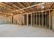 Unfinished basement offering a blank canvas with exposed beams, concrete foundation, and visible framing at 363 Riverwood Pass, Dallas, GA 30157