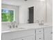 Well-lit bathroom with a large mirror and double vanity at 363 Riverwood Pass, Dallas, GA 30157
