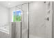 Luxurious bathroom featuring soaking tub, separate shower with glass door, and serene outdoor view at 363 Riverwood Pass, Dallas, GA 30157