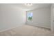 Carpeted bedroom with natural light, featuring neutral walls and bright white trim at 363 Riverwood Pass, Dallas, GA 30157