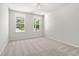 Well-lit bedroom with two large windows offering views of the outdoors and neutral carpet at 363 Riverwood Pass, Dallas, GA 30157