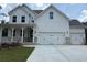 Charming two-story home featuring a three-car garage, covered porch, and white siding at 363 Riverwood Pass, Dallas, GA 30157
