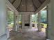Outdoor gazebo with stone flooring, a brick fireplace, and large columns, providing a relaxing space at 363 Riverwood Pass, Dallas, GA 30157
