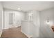 Upstairs hallway with an oak railing and wood floors leading to bedrooms at 363 Riverwood Pass, Dallas, GA 30157