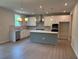 Spacious kitchen featuring stainless steel appliances, ample lighting, and a gray kitchen island at 363 Riverwood Pass, Dallas, GA 30157
