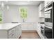 Bright kitchen featuring a center island, modern appliances, and a window overlooking the outdoors at 363 Riverwood Pass, Dallas, GA 30157