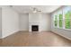 Bright living room with hardwood floors, a fireplace, and large windows offering scenic views at 363 Riverwood Pass, Dallas, GA 30157