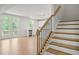Open-concept living space with a kitchen, doors to balcony, and a staircase at 363 Riverwood Pass, Dallas, GA 30157