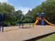 Colorful playground with swings, slides and a climbing structure, surrounded by green grass at 363 Riverwood Pass, Dallas, GA 30157
