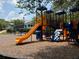 Fun playground with slides and climbing structures in a grassy, tree-lined community area at 363 Riverwood Pass, Dallas, GA 30157
