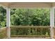 Covered porch offering a serene view of the surrounding trees and greenery at 363 Riverwood Pass, Dallas, GA 30157