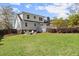 Grassy backyard featuring a fire pit and patio with mature landscaping for outdoor enjoyment at 385 Jayne Ellen Way, Alpharetta, GA 30009