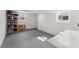 Unfinished basement offering ample storage, featuring painted concrete walls, a utility door, and shelving at 385 Jayne Ellen Way, Alpharetta, GA 30009