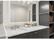 Elegant bathroom with a double vanity, marble countertops, modern fixtures, and decorative storage solutions at 385 Jayne Ellen Way, Alpharetta, GA 30009