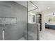Luxurious bathroom featuring a glass-enclosed shower, decorative tiles, and access to the spacious main bedroom at 385 Jayne Ellen Way, Alpharetta, GA 30009