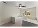 Bright bedroom featuring two beds, a ceiling fan, and a window with a view of the outdoors at 385 Jayne Ellen Way, Alpharetta, GA 30009